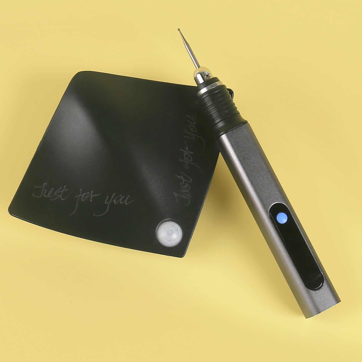 D2-002 Engraving pen writing 'Just for you' on black plastic surface – ideal for custom messages.